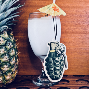 Pina Grenada Air Freshener next to a pineapple and Pina colada